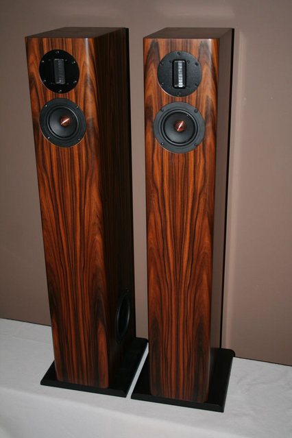 Pair of HT3 tower speakers in rosewood veneer on black plinths, a ribbon tweeter above the midrange on each front