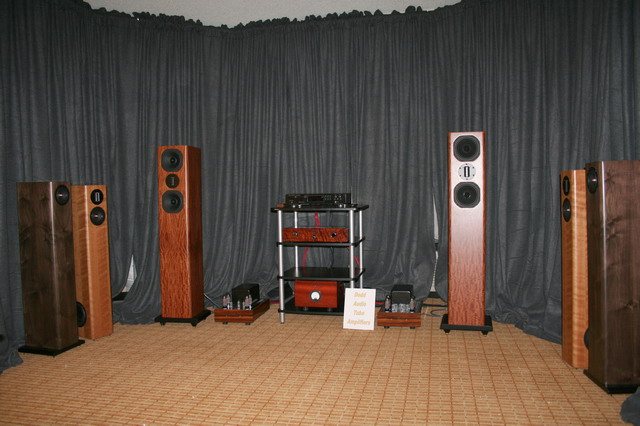RAW Acoustics room at the Rocky Mountain Audio Fest 2006: tower speakers in wood veneers either side of an equipment rack with tube amplifiers